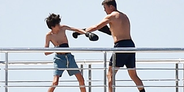 Brady has a training session with his son while vacationing on a yacht in Portofino, Italy. 