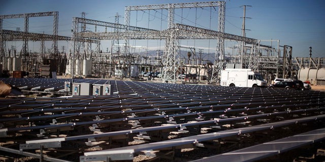 Solar panels are pictured next to a Southern California Edison electricity station in Carson, California, in March 2022.
