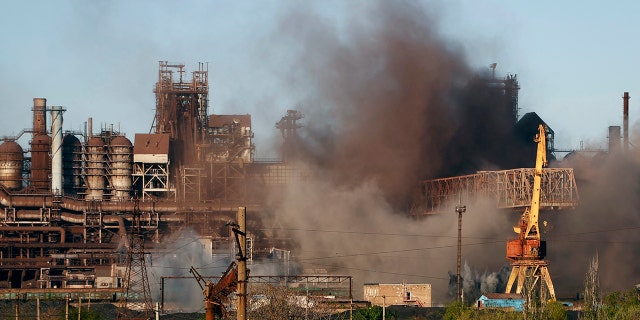 FILE - Smoke rises from the Metallurgical Combine Azovstal in Mariupol during shelling, in Mariupol, in territory under the government of the Donetsk People's Republic, eastern Ukraine, Saturday, May 7, 2022. (AP Photo/Alexei Alexandrov, File)