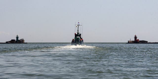 Russian Navy boat of the Black Sea Fleet patrols an aria of the Mariupol Sea Port in Mariupol, in territory under the government of the Donetsk People's Republic, eastern Ukraine, Monday, May 30, 2022. 