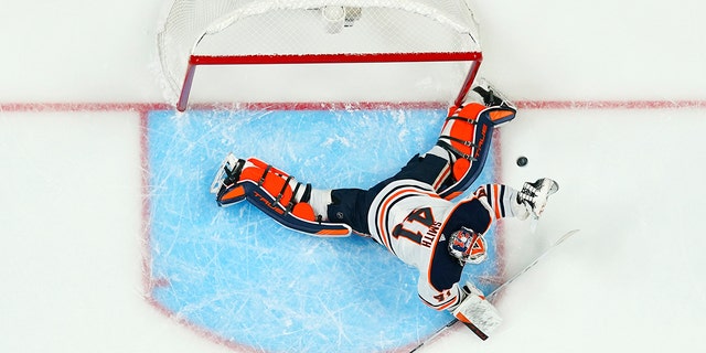Edmonton Oilers goaltender Mike Smith gives up a goal to Colorado Avalanche left wing J.T. Compher during the first period in Game 1 of the NHL hockey Stanley Cup playoffs Western Conference finals Tuesday, May 31, 2022, in Denver. 