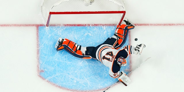 Edmonton Oilers goaltender Mike Smith gives up a goal to Colorado Avalanche left wing J.T. Compher during the first period in Game 1 of the NHL hockey Stanley Cup playoffs Western Conference finals Tuesday, May 31, 2022, in Denver.