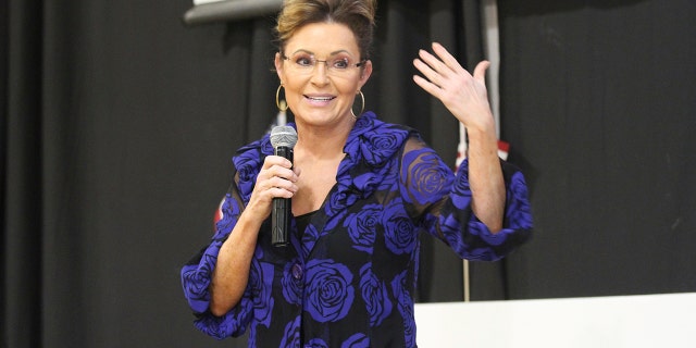 Sarah Palin, a Republican seeking the sole U.S. House seat in Alaska, addresses supporters Thursday, June 2, 2022, in Anchorage, Alaska, during an event that featured former President Donald Trump whose voice was heard over loudspeakers in a church gym. (AP Photo/Mark Thiessen)