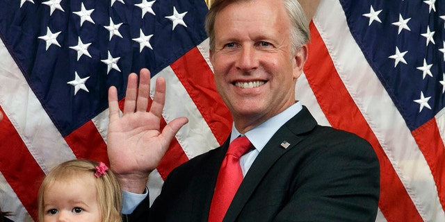 Congressman Chris Jacobs, R-N.Y., center, poses for a photo with his daughter Anna, 1, during a ceremonial swearing-in on Capitol Hill, July 21, 2020, in Washington. Jacobs says he will not run for another term in Congress amid backlash over his support for new gun control measures. (AP Photo/Jacquelyn Martin, File)