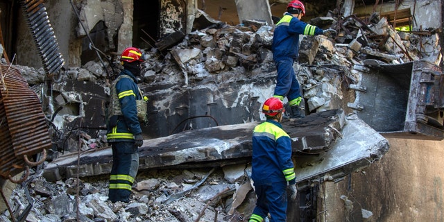 Ukrainian rescue workers are working outside a damaged building after a bombardment in Kharkiv, Ukraine, on Saturday, June 4, 2022.