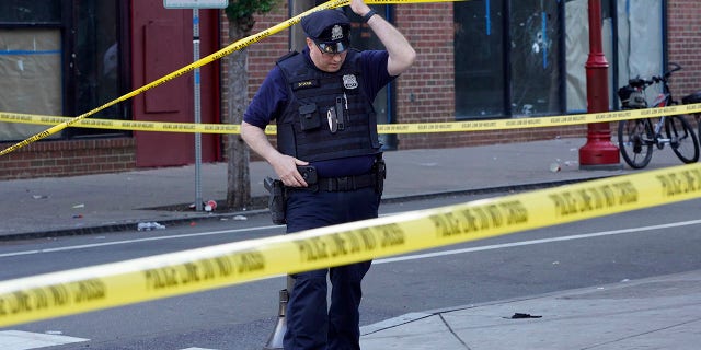 Philadelphia Police investigators work the scene of a fatal overnight shooting on South Street in Philadelphia, Sunday, June 5, 2022. 