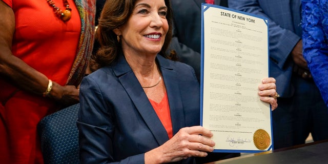 New York Gov. Kathy Hochul poses for photographers after signing a package of bills to strengthen gun laws, Monday, June 6, 2022, in New York.