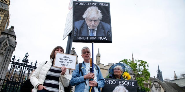 Protesters calling for the removal of British Prime Minister Boris Johnson, demonstrate outside the Houses of Parliament in London on Monday. Johnson faces a no-confidence vote Monday that could oust him from power, as discontent with his rule finally threatens to topple a politician who has often seemed invincible despite many scandals.