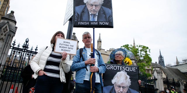 Protesters calling for the removal of British Prime Minister Boris Johnson, demonstrate outside the Houses of Parliament in London on Monday. Johnson faces a no-confidence vote Monday that could oust him from power, as discontent with his rule finally threatens to topple a politician who has often seemed invincible despite many scandals.