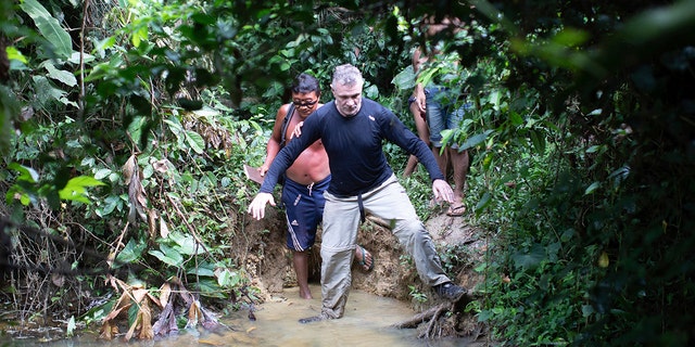 British journalist Dom Phillips, right, and a Yanomami Indigenous man walk in Maloca Papiu village, Roraima state, Brazil, Nov. 2019. Phillips and Indigenous affairs expert Bruno Araujo Pereira have been reported missing in a remote part of Brazil's Amazon region, a local Indigenous association said Monday, June 6, 2022. 