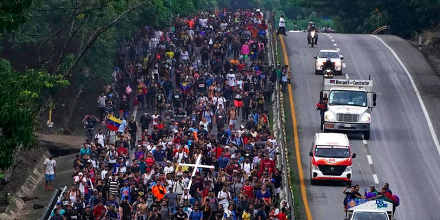 Migrants, many from Central American and Venezuela, walk along the Huehuetan highway in Chiapas state, Mexico, early Tuesday, June 7, 2022. (AP Photo/Marco Ugarte)