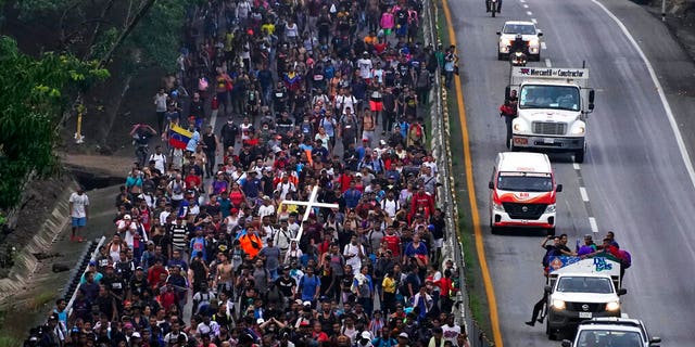 Migrants, many from Central America and Venezuela, walk along the Huehuetan highway in Chiapas state, Mexico, early Tuesday, June 7, 2022. 