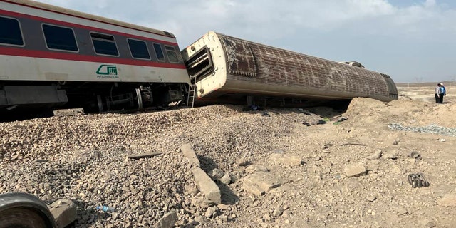 This photo provided by the Iranian Red Crescent Society shows the scene where a passenger train partially derailed near the desert city of Tabas in eastern Iran, Wednesday, Iran, Wednesday, June 8, 2022. (Iranian Red Crescent Society via AP)
