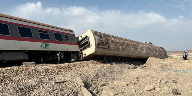 This photo provided by the Iranian Red Crescent Society shows the scene where a passenger train partially derailed near the desert city of Tabas in eastern Iran, Wednesday, Iran, Wednesday, June 8, 2022. (Iranian Red Crescent Society via AP)