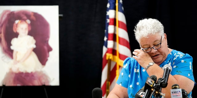 Debbie Carlson, mother of murdered 8-year-old Vicki Lynne Hoskinson, wipes away a tear as she speaks at a news conference after Frank Atwood was put to death by lethal injection at the Arizona state prison Wednesday, June 8, 2022, in Florence, Ariz.