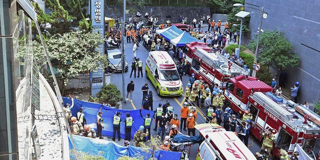 South Korean rescue teams and firefighters work at the scene in Daegu, South Korea, Thursday, June 9, 2022. At least seven people were killed and dozens of others were injured Thursday in a fire that spread through an office building in South Korea's Daegu city, local fire and police officials said. (Lee Mu-yeol/Newsis via G3 Box News)