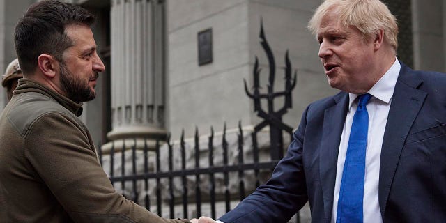 FILE - In this image provided by the Ukrainian Presidential Press Office, Ukrainian President Volodymyr Zelenskyy, left, and Britain's Prime Minister Boris Johnson, shake hands during their walk in downtown Kyiv, Ukraine, Saturday, April 9, 2022. When British Prime Minister Boris Johnson survived a no-confidence vote this week, at least one other world leader shared his relief. Ukrainian President Volodymyr Zelenskyy said it was "great news" that "we have not lost a very important ally." (Ukrainian Presidential Press Office via AP, File)