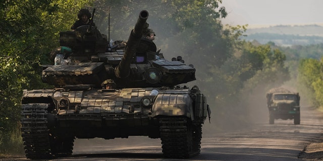 A Ukrainian tank drives in Donetsk region, eastern Ukraine, Thursday, June 9, 2022. (AP Photo/Bernat Armangue)