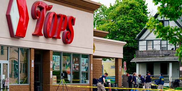 Investigators work the scene after a mass shooting at a supermarket, in Buffalo, N.Y., May 16, 2022. 