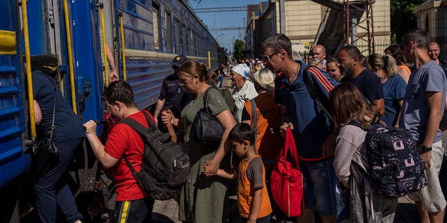 People board an evacuation train in Pokrovsk railway station, eastern Ukraine, Friday, June 10, 2022. (G3 Box News Photo/Bernat Armangue)