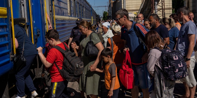 People board an evacuation train in Pokrovsk railway station, eastern Ukraine, Friday, June 10, 2022. (AP Photo/Bernat Armangue)