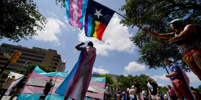 Demonstrators gather on the steps of the State Capitol to speak against transgender-related legislation bills being considered in the Texas Senate and Texas House, May 20, 2021, in Austin, Texas.