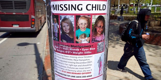 A man walks past a "missing child" poster for Harmony Montgomery, Thursday, May 5, 2022, in Manchester, N.H. A former home of the father and stepmother of Montgomery, missing since 2019 at age 5, is being searched in Manchester as part of the investigation into her disappearance, police said Tuesday, June 14, 2022.