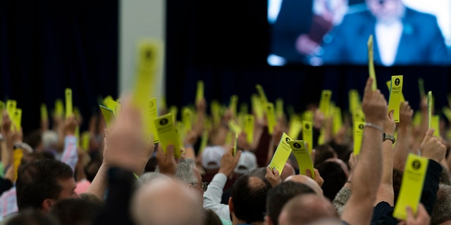 Attendees hold up their ballots during a session at the Southern Baptist Convention's annual meeting in Anaheim, Calif., Tuesday, June 14, 2022.