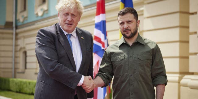 In this image provided by the Ukrainian Presidential Press Office, Ukrainian President Volodymyr Zelenskyy, right, and Britain's Prime Minister Boris Johnson, pose for a photo during their meeting in downtown Kyiv, Ukraine, Friday, June 17, 2022.