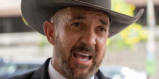 Otero County, New Mexico Commissioner Couy Griffin speaks to reporters as he arrives at the federal court in Washington, Friday, June. 17, 2022. 