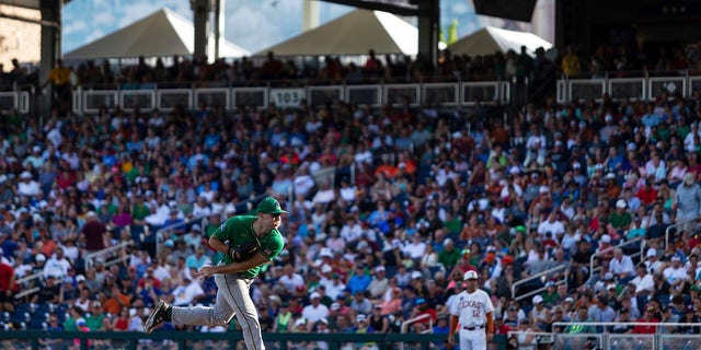 Notre Dame pitcher John Michael Bertland is watching a throw to a Texas batter during three innings of the NCAA College World Series baseball game on Friday, June 17, 2022 in Omaha, Nebraska. 