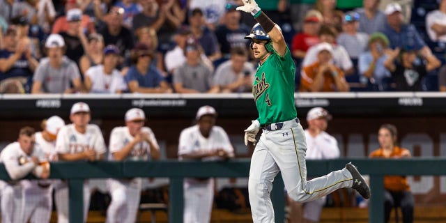 Notre Dame' Carter Putz (4) scores against Texas during the ninth inning of an NCAA College World Series baseball game Friday, June 17, 2022, in Omaha, Neb.