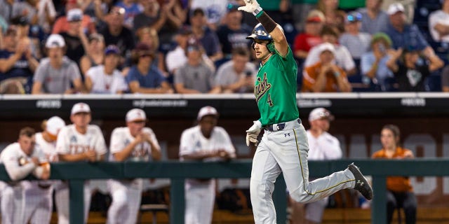 Notre Dame' Carter Putz (4) scores against Texas during the ninth inning of an NCAA College World Series baseball game Friday, June 17, 2022, in Omaha, Neb. 