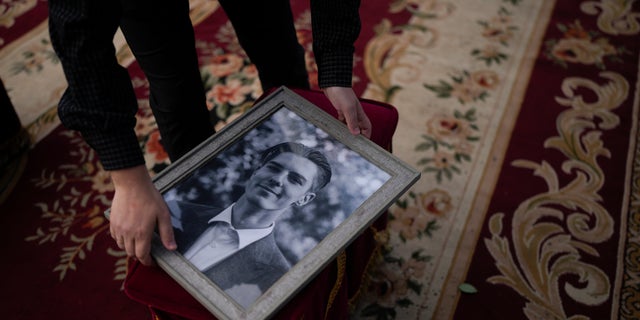 A man holds a photo of activist and soldier Roman Ratushnyi before the start of the memorial service in Kyiv, Ukraine, Saturday, June 18, 2022. Ratushnyi died in a battle near Izyum, where Russian and Ukrainian troops are fighting for control of the area. (WHD Photo/Natacha Pisarenko)