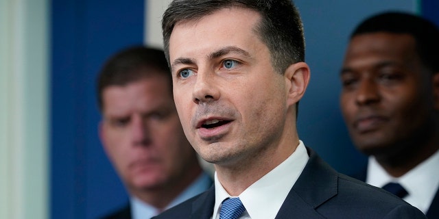 FILE - Transportation Secretary Pete Buttigieg, center, speaks during a briefing at the White House in Washington, May 16, 2022, as Labor Secretary Marty Walsh, left, and Environmental Protection Agency administrator Michael Regan, right, listen.  (AP Photo/Susan Walsh, File)