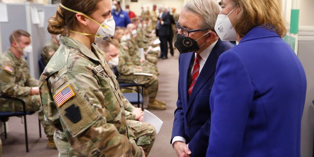 Ohio Gov. Mike DeWine and his wife Fran talk with specialist Emily Milosevic as they tour the Defense Supply Center in Columbus, Ohio, in January 2022.