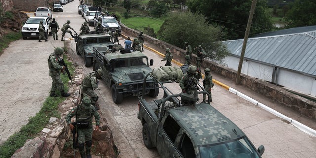 Mexican army vehicles arrive at Cerocahui, Mexico church following the murders.