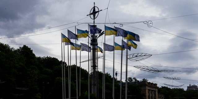 Ukrainian and EU flags on poles, in Kyiv, Ukraine, Thursday, June 23, 2022. European Union leaders on Thursday are set to grant Ukraine candidate status to join the 27-nation bloc, a first step in a long and unpredictable journey toward full membership that could take many years to achieve. 