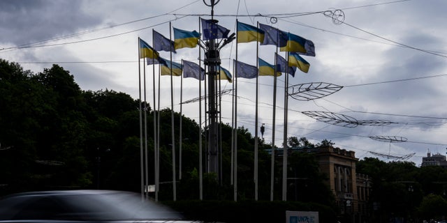 Ukrainian and EU flags on poles, in Kyiv, Ukraine, Thursday, June 23, 2022. European Union leaders on Thursday are set to grant Ukraine candidate status to join the 27-nation bloc, a first step in a long and unpredictable journey toward full membership that could take many years to achieve.