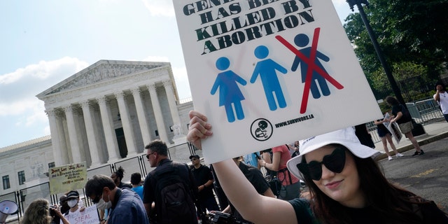 Faith Adams from Bangor, Maine, protests about abortion, Friday, June 24, 2022, outside the Supreme Court in Washington. (AP Photo/Steve Helber)