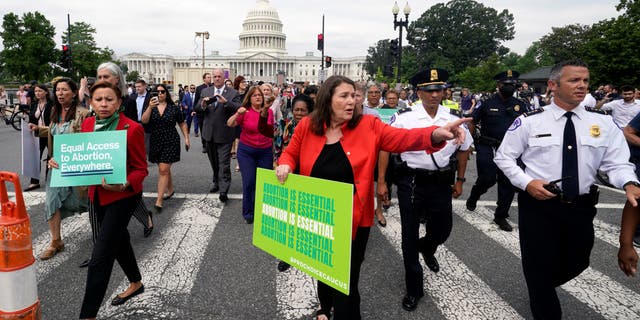 Members of the House of Representatives walk from the Capitol to the Supreme Court to protest the abortion decision, Friday, June 24, 2022.