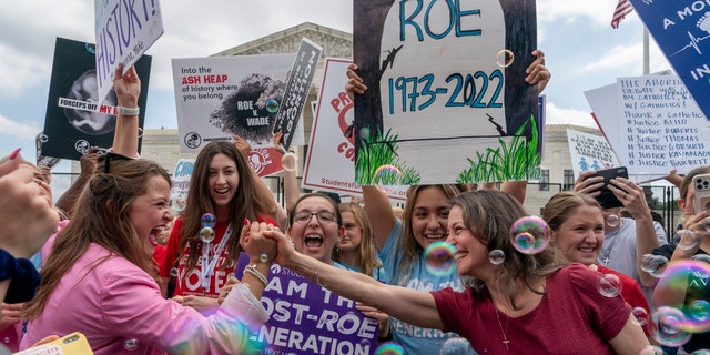 Pro life women celebrate following Supreme Court's decision to overturn Roe v. Wade, outside the Supreme Court in Washington, Friday, June 24, 2022.