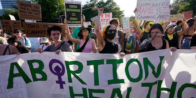 Demonstrators march and gather near the state capitol following the Supreme Court's decision to overturn Roe v. Wade in Austin, Texas. Texas Attorney General Ken Paxton is being sued by health care providers over allegedly threatening ot prosecute abortion providers.