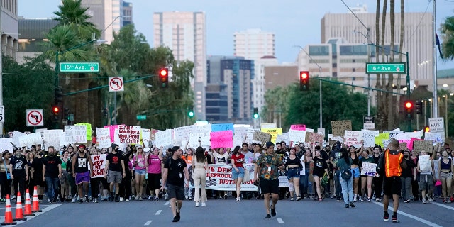 Thousands of protesters march around the Arizona Capitol after the Supreme Court decision to overturn the landmark Roe v. Wade abortion decision Friday, June 24, 2022, in Phoenix. (AP Photo/Ross D. Franklin)