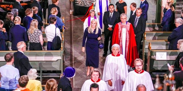 Norway's Crown Princess Mette-Marit, center, and Rev. Olav Fykse Tveit, center right, leave after a service in Oslo Cathedral, Oslo, Sunday June 26, 2022, after an attack in Oslo on Saturday. A gunman opened fire in Oslo’s nightlife district early Saturday, killing two people and leaving more than 20 wounded in what the Norwegian security service called an "Islamist terror act" during the capital’s annual LGBTQ Pride festival. (Javad Parsa/NTB via AP)