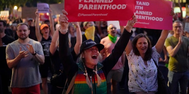 Supporters of abortion rights chant slogans outside a Planned Parenthood clinic during a protest in West Hollywood, Calif. The U.S. Supreme Court's decision to end constitutional protections for abortion has cleared the way for states to impose bans and restrictions on abortion — and will set off a series of legal battles. 