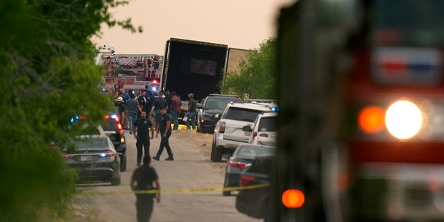 Body bags lie at the scene where a tractor trailer with multiple dead bodies was discovered, Monday, June 27, 2022, in San Antonio.