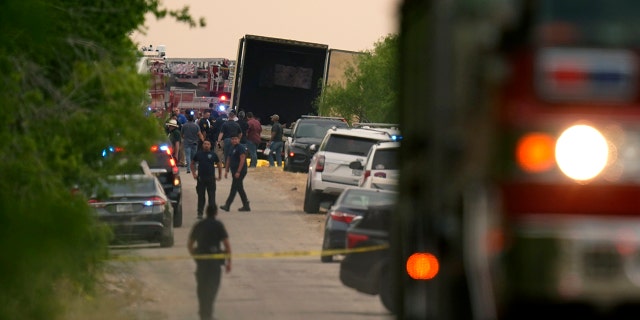 Body bags lie at the scene where a tractor trailer with multiple dead bodies was discovered, Monday, June 27, 2022, in San Antonio.