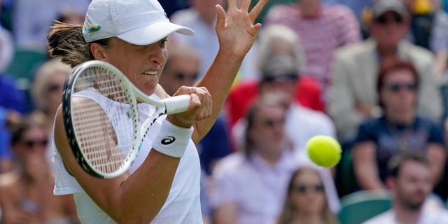 Poland's Iga Swiatek returns to Croatia's Jana Fett in a women's singles match at the Wimbledon tennis championships in London June 28, 2022. 