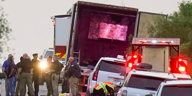 Police and other first responders work the scene where officials say dozens of people have been found dead and multiple others were taken to hospitals with heat-related illnesses after a semitrailer containing suspected migrants was found Monday, June 27, 2022, in San Antonio, Texas. 